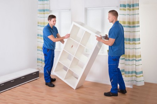 Piano removal team planning access in an Ilford property